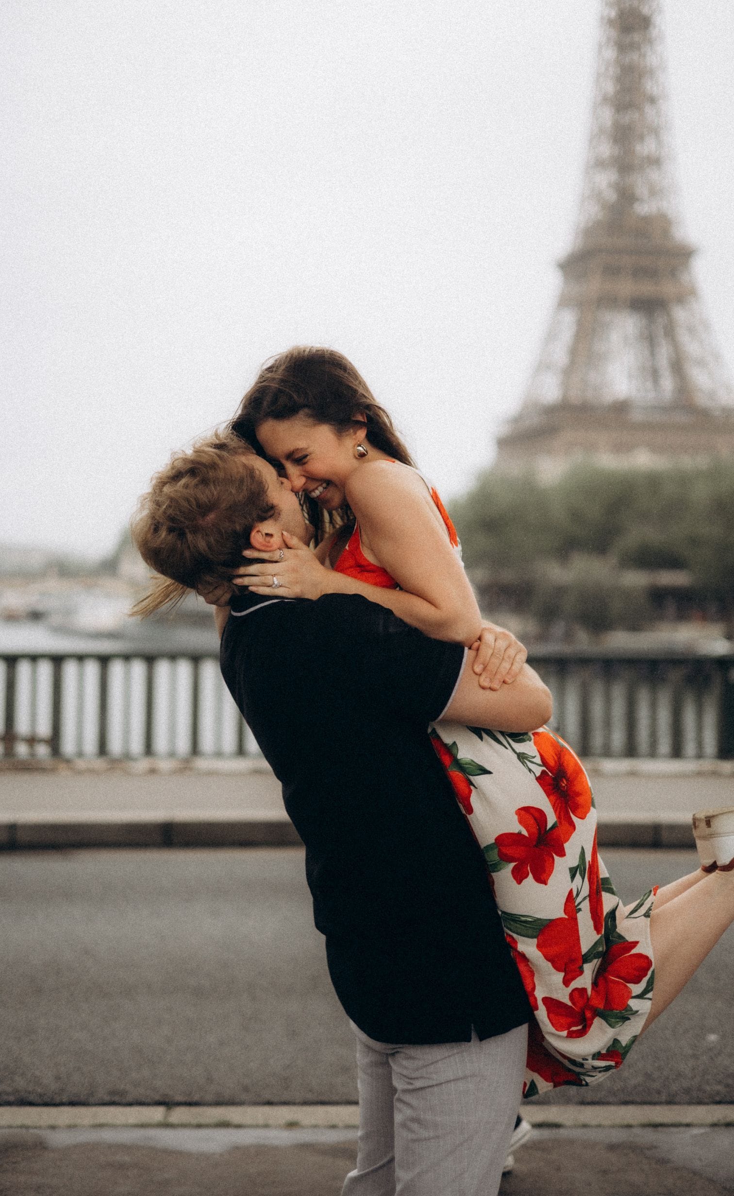 Couple kissing in Paris with Eiffel Tower in background